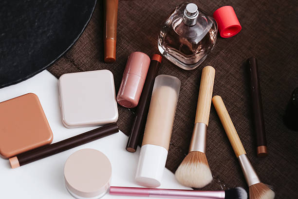 istock Makeup products and brushes. Beauty cosmetics on table background. Professional tools for makeup artist. 2239400738