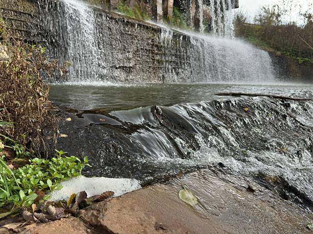istock Waterfall on the river in the forest. Dam on the river, spillway. 2239401004