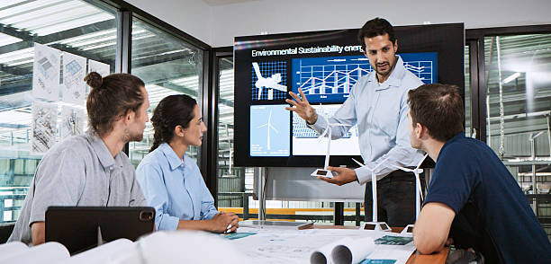 istock Engineer team brainstorm meeting in factory office. Presentation on ESG project planning. Solar panel, wind turbine electrical power generation, environmental sustainable energy. Industrial business 2239402025