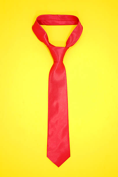 istock Red tie isolated on yellow background close-up view 2239405177