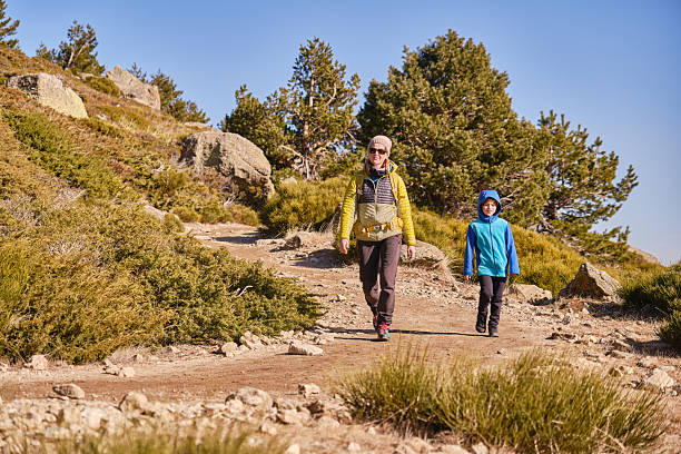 istock Mother and son descending a mountain path 2239405339