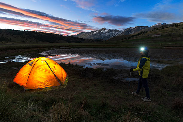 istock Hiker with tent admiring mountains at sunset 2239405658