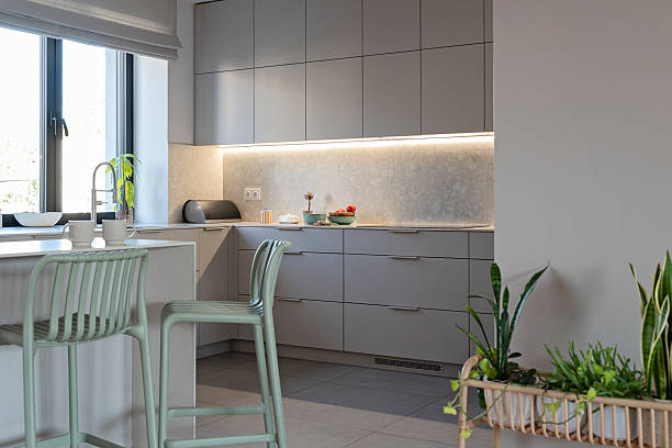 istock Home interior of modern kitchen with kitchen sink by the window, dining table with mint green chair. Indoors architecture. 2239411877