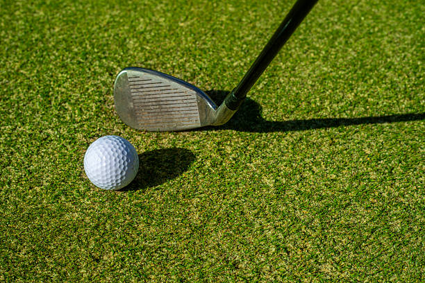 istock Close-up of golf clubs on a sunny course 2239411942