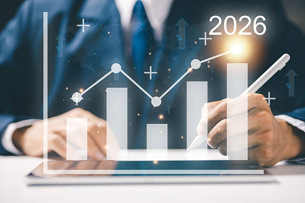 istock A businessman analyzing financial growth chart with rising bars labeled 2026. Concept of business success, financial forecast, profit growth, and economic trend for future planning. 2239412289