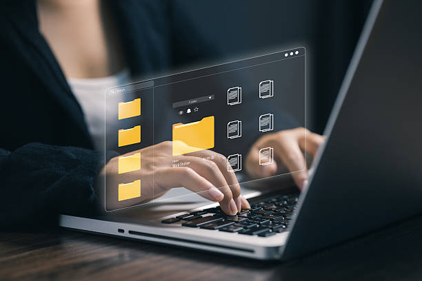 istock A person using a laptop with holographic digital folders and documents interface. Concept of cloud computing, data management, digital archive, and virtual storage technology. 2239412291