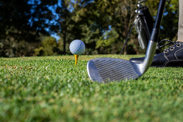 istock Close-up of golf clubs on a sunny course 2239412509