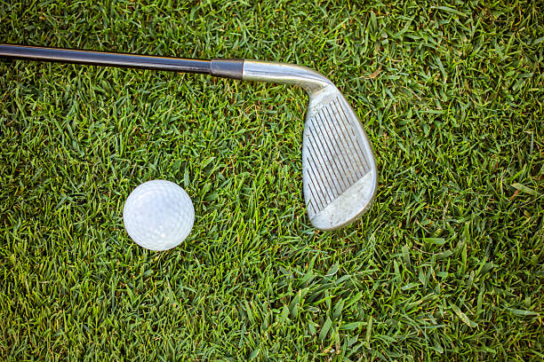 istock Close-up of golf clubs on a sunny course 2239415672