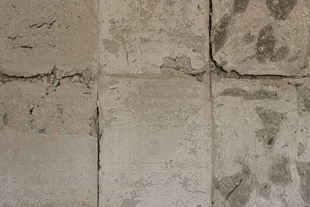 istock An old concrete wall with uneven surfaces and tile marks, a surface with cracks and chips, related to construction, renovation 2239418614