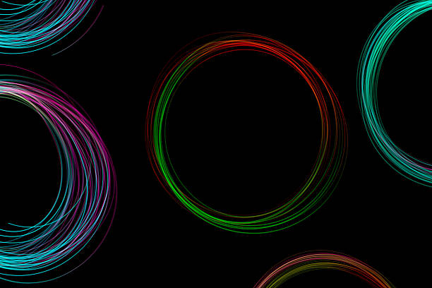 Colorful freeze light circles spin and glow against a black background, showcasing a beautiful display of vibrant patterns in motion.