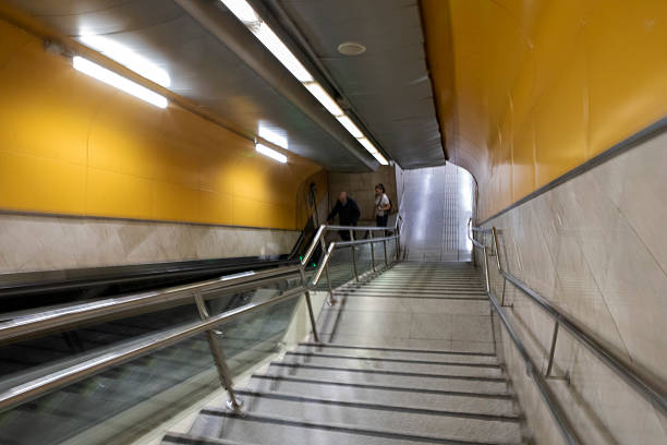 Empty escalator in a contemporary underground metro station with metallic design.