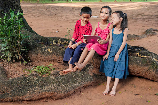 istock Cambodian children using digital tablet in village, Cambodia 2239428479