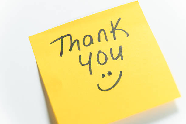 istock Thank you message on yellow sticky note with smiley face 2239430281
