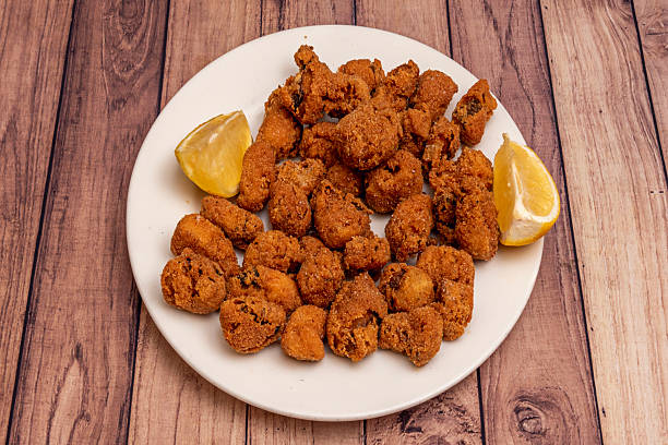 istock A plate of breaded fish with lemon slices 2239431594