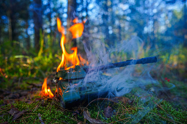 istock Military Toy Tank Catches Fire in Forest During Bright Sunny. 2239433911