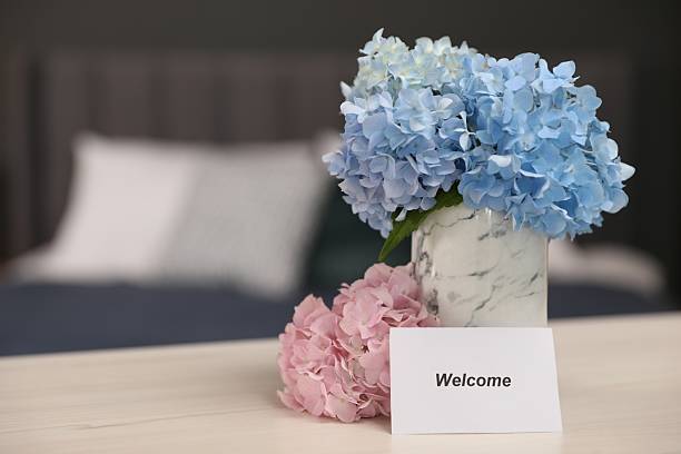 istock Card with word Welcome and hydrangea flowers on wooden table, space for text 2239443174