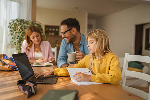 istock Little girl doing homework and learning online with parents 2239444475