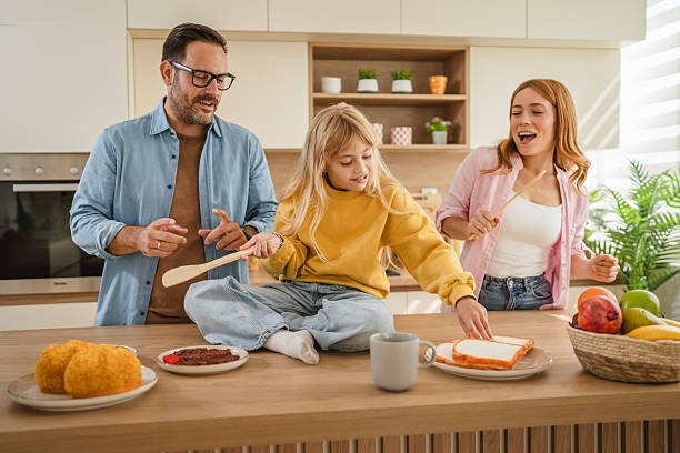 istock Family enjoying fun morning dancing and cooking in kitchen 2239444531
