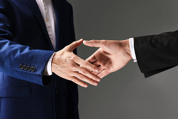 istock Business partners shaking hands on grey background, closeup 2239446383