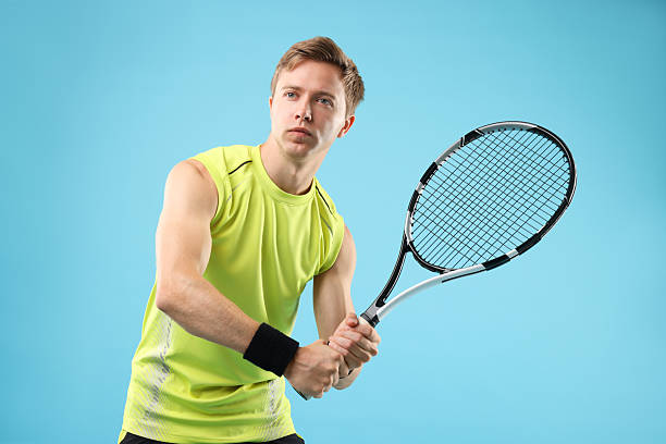istock Man with tennis racket on light blue background 2239446386