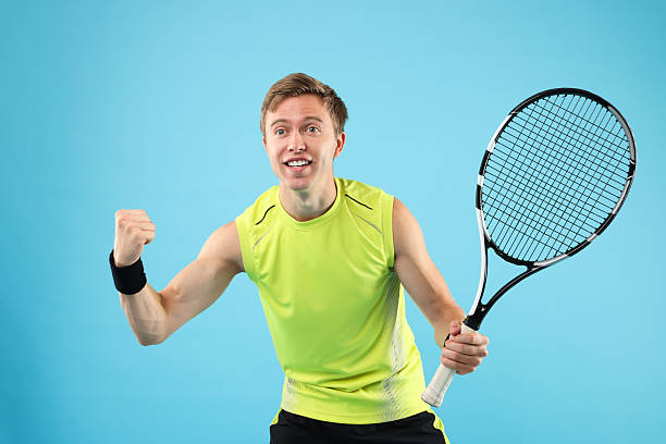 istock Man with tennis racket on light blue background 2239446388