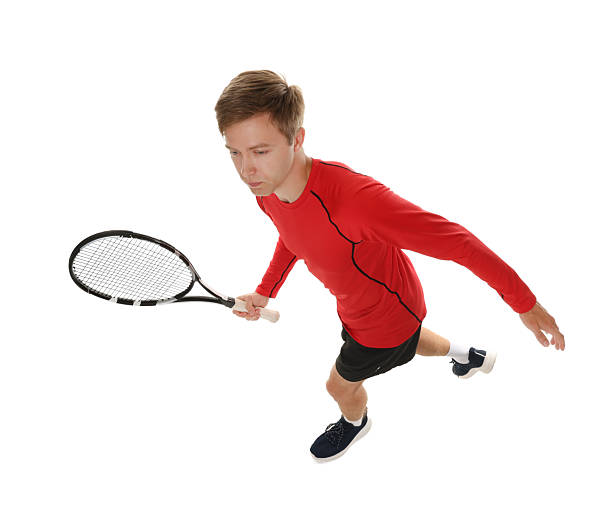 Man with tennis racket on white background, above view