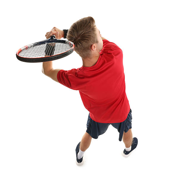 Active, dynamic. One young man, male professional tennis player in red uniform training isolated on white background. Concept of active life, team game, energy, sport, competition. Copy space for ad