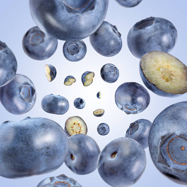 istock Fresh blueberries swirling in air against pale blue background 2239446877