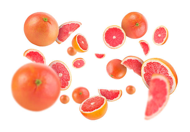 istock Fresh grapefruits swirling in air against white background 2239446888