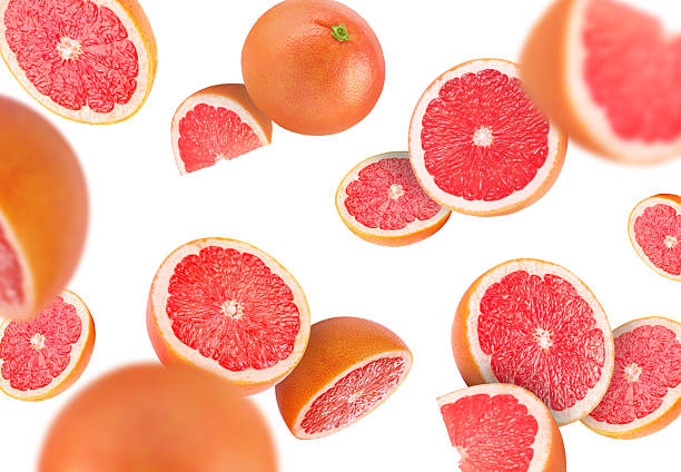 istock Fresh grapefruits swirling in air against white background 2239446899
