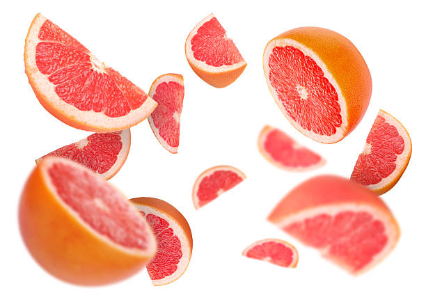 istock Fresh grapefruits swirling in air against white background 2239446904