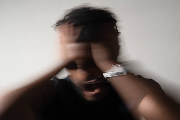 Adult man suffering from anxiety and frustration, screaming in despair