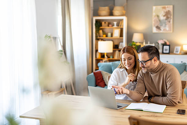 istock Couple brainstorming ideas on laptop in stylish home setup. 2239455751