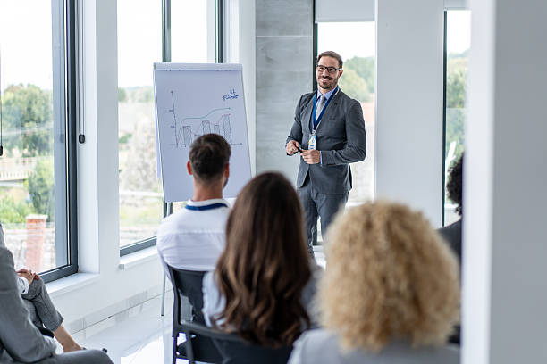 istock Engaging Corporate Meeting with Focused Audience Attendees 2239461174