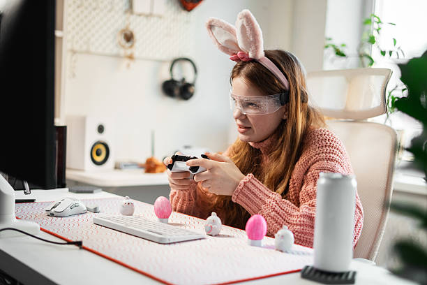 istock Playful Easter gaming session. Girl with controller sits in cozy decorated space, combining love for video games and seasonal aesthetics into immersive experience. 2239464007