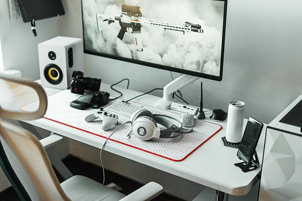 istock Cozy gaming space featuring modern setup with computer, large monitor, ergonomic chair, organized desk. On table headphones, smartphone, mouse pad and energy drink improve concentration and comfort. 2239464447