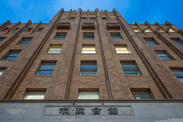 Low angle view of a historic brick building in Tokyo. Hibiya City hall, built in 1929 is now a government administration building in Tokyo.