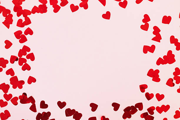 istock Happy valentines day. Stylish red hearts confetti frame on pink background flat lay with copy space. Love background 2239470036