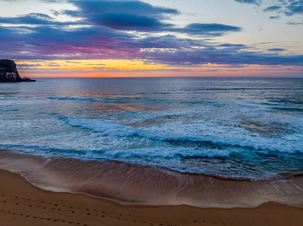istock Seaside Sunrise Under a Cloud-Filled Sky 2239475431