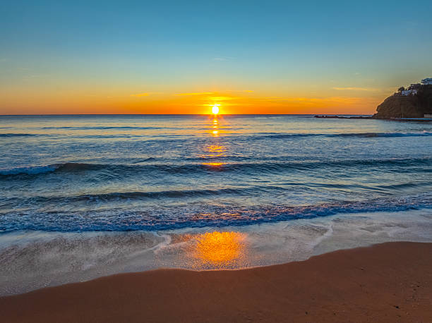 istock Ocean Sunrise Under Clear Skies with Orange Horizon 2239475486