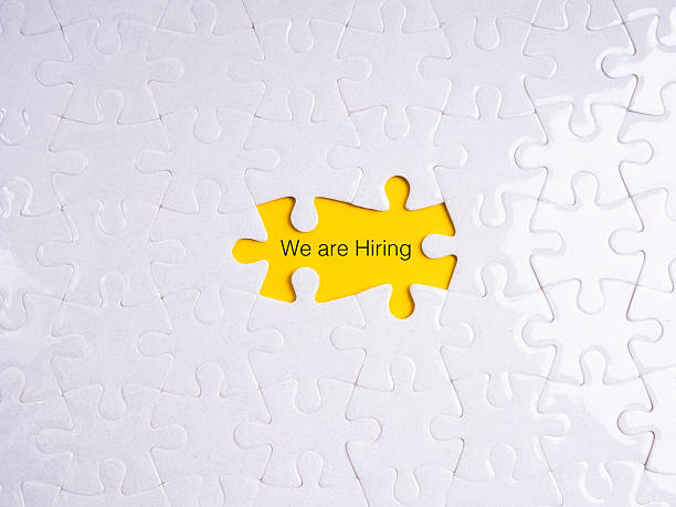 istock Hiring and recruitment concept with puzzle piece missing showing yellow background and text We are Hiring, symbolizing job vacancy, employment opportunity, HR search, career growth, and team building. 2239475585