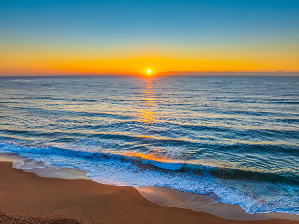 istock Sunrise at the Seaside with Clear Blue Skies 2239475742