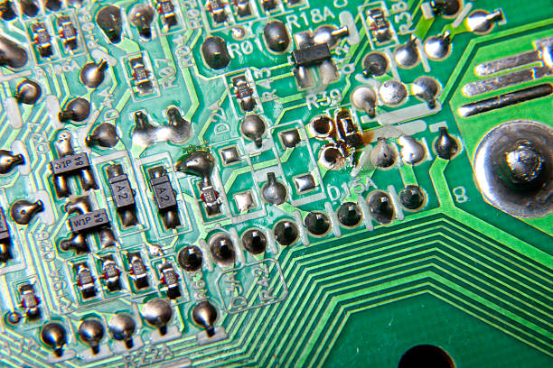 istock A fragment of an electronic printed circuit board with tracks and electronic components 2239475896