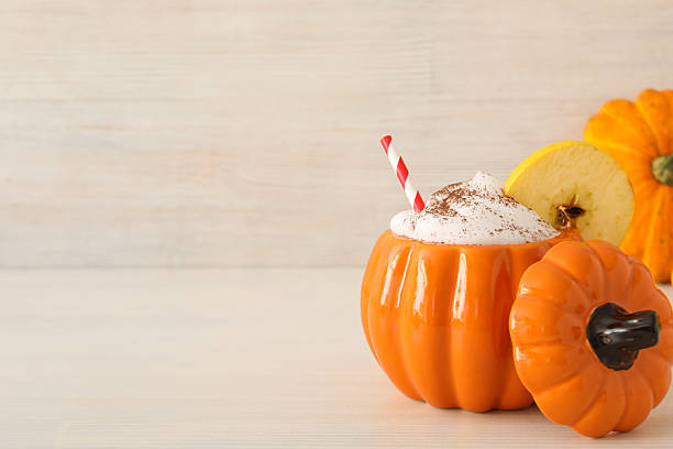 istock Coffee in glass pumpkin on wooden background, space for text 2239476541