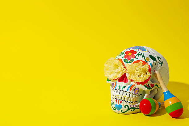 istock Mexican skull, flowers and maracas on yellow background, space for text 2239477471