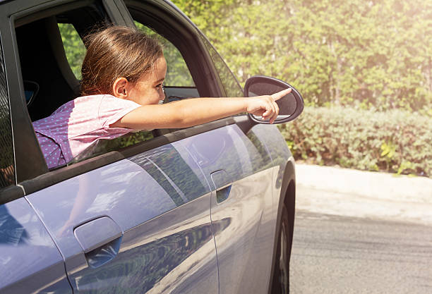 istock Child points finger out of car window 2239481528