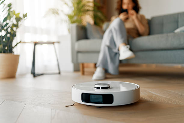 istock White robotic vacuum cleaner on wooden floor 2239484390