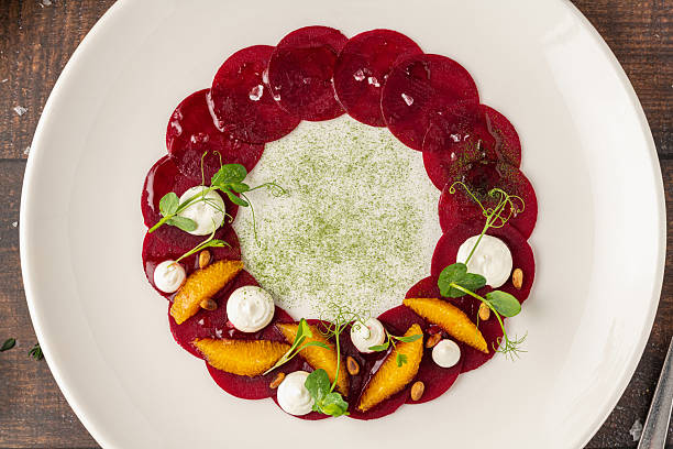 istock Beet carpaccio with orange slices, fresh greens and cream dots 2239484779