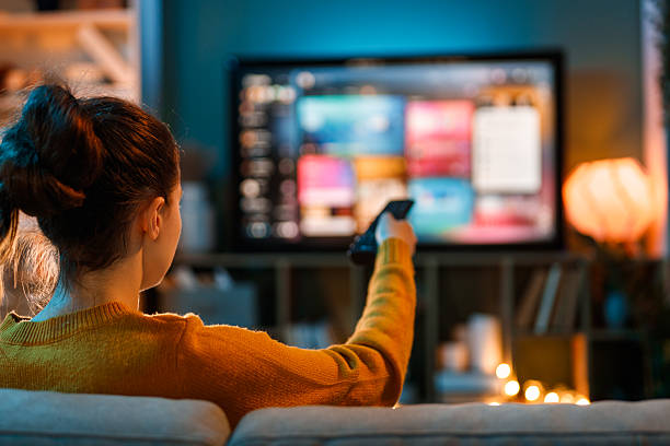 istock woman watching TV at home 2239484803
