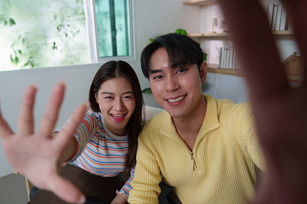 istock Young couple sharing joyful moment on video call, engaging with friends 2239484809